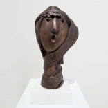 Bronze scupture, of an abstract face inspired by the traditional costume of Santorini women, by Greek contemporary artist, Eleni Kolaitou at AK Greek art gallery
